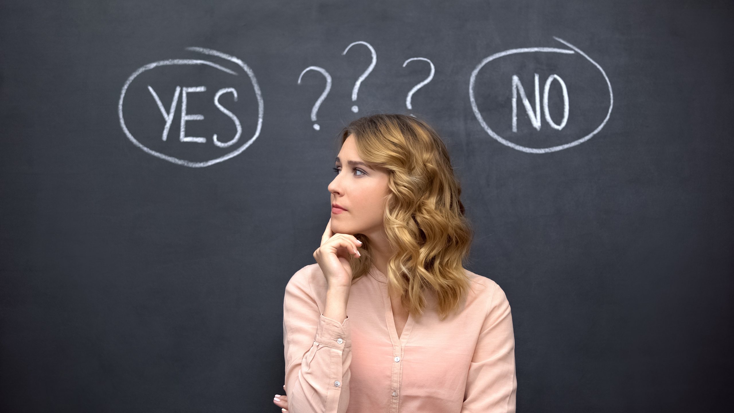 Puzzled woman choosing between yes no, stereotype of uncertain f